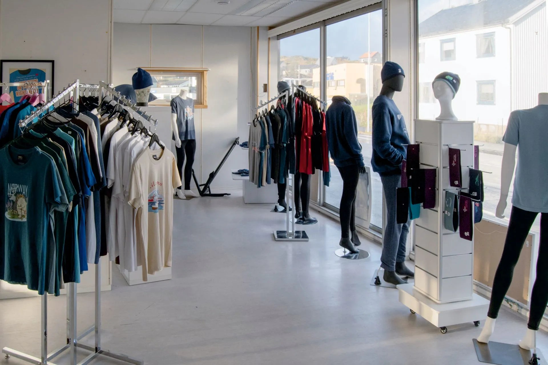 Interiøret i butikken med våre produkter på kleshengere.